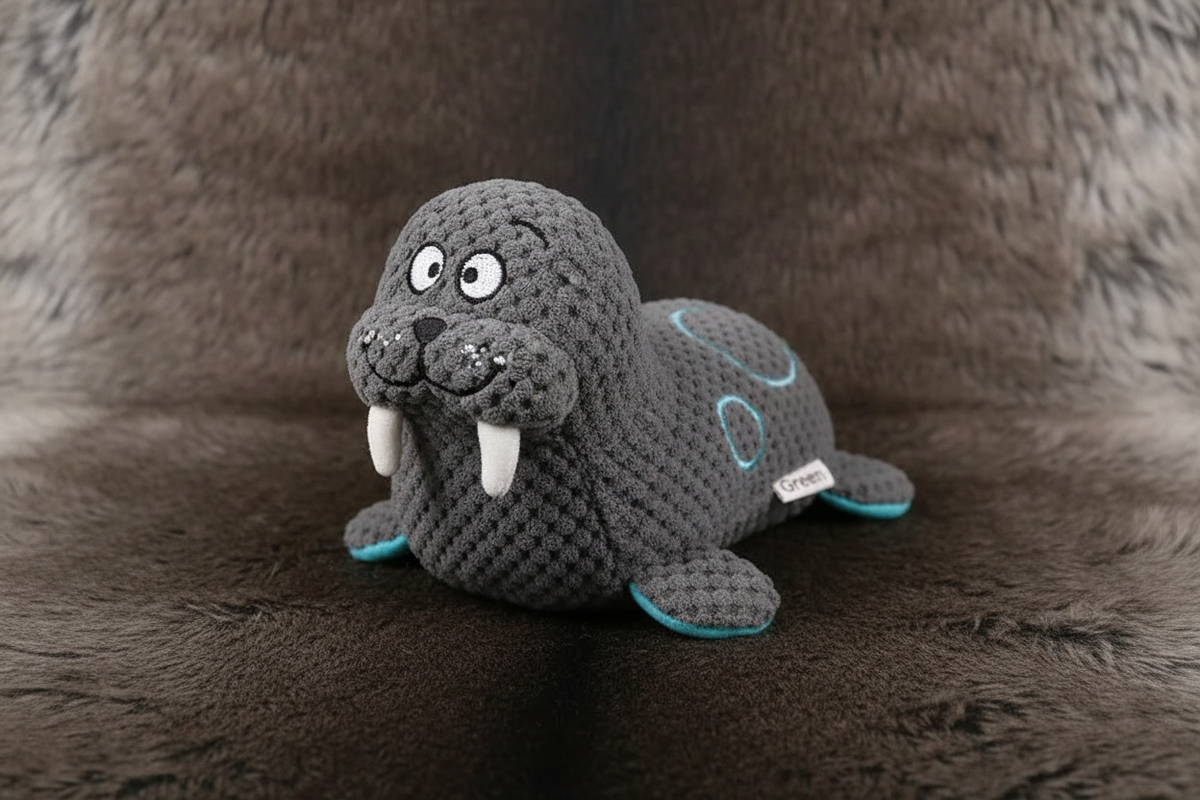 Green accent walrus plush squeaky dog toy hero shot on faux fur