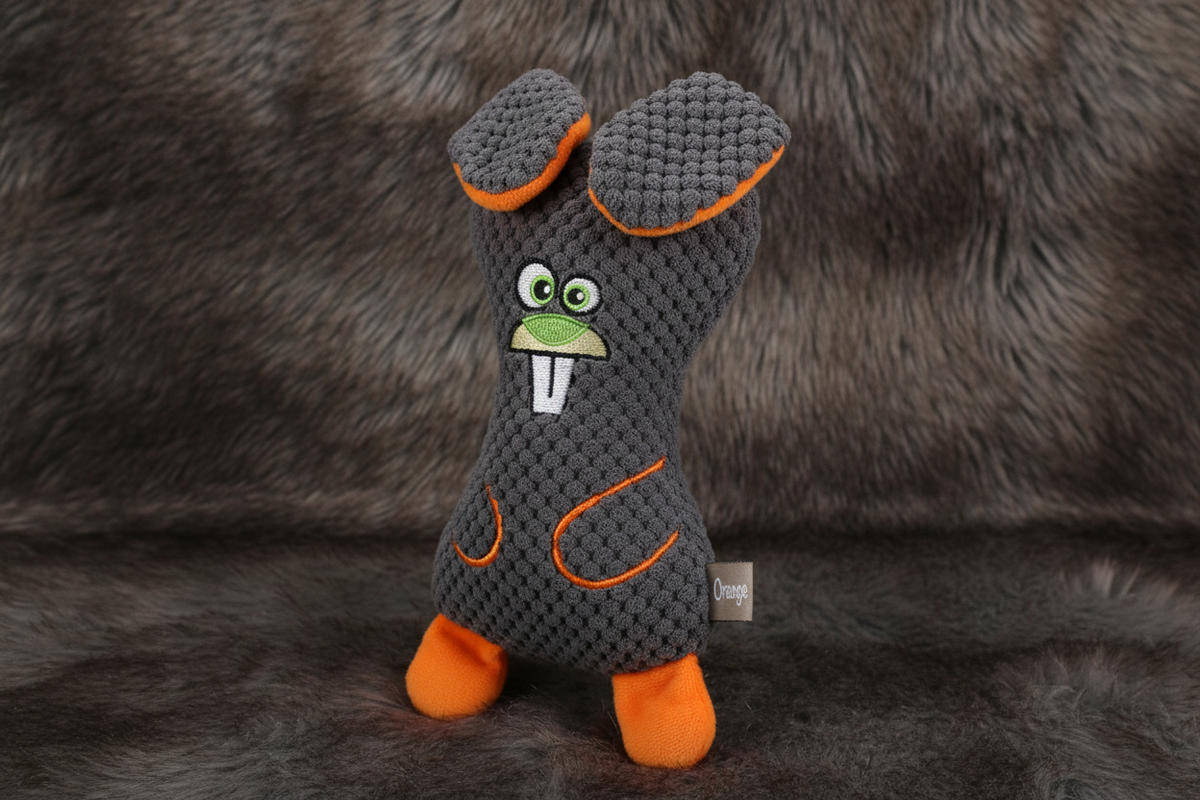 Orange accent dog bear plush squeaky toy hero shot on faux fur